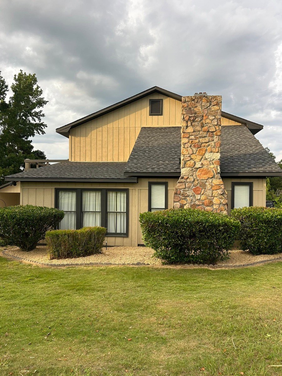 Trimmed shrubs and rock landscape beds in front of a home near Columbus, GA